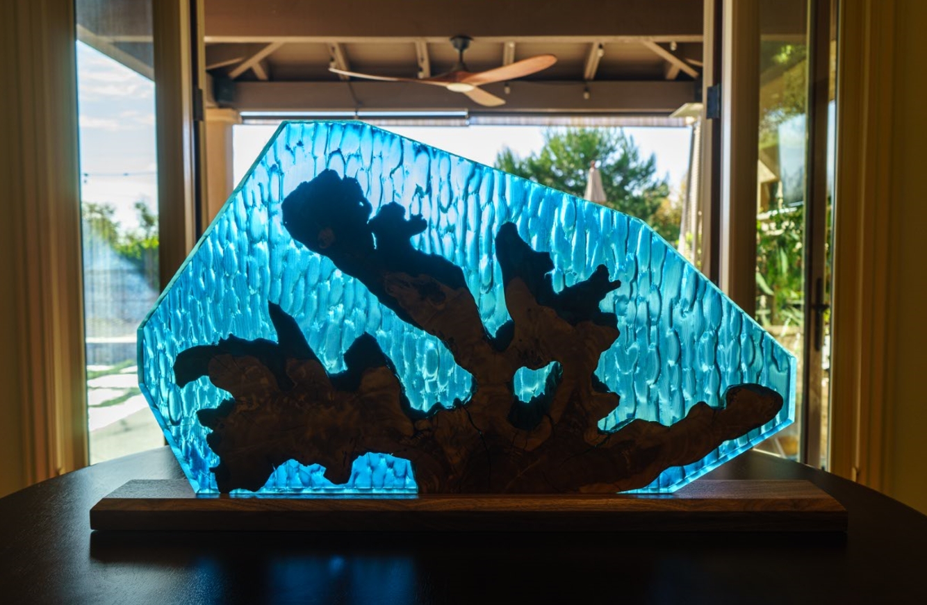 a blue coral leaf made with deep pour epoxy resin and olivewood