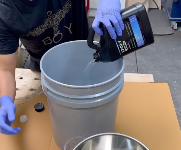 pouring deep pour epoxy resin into a mixing can