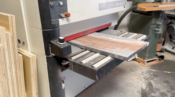 sanding Epoxy Resin Table made with walnut and epoxy resin