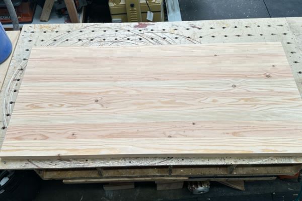 sanding 20-foot construction lumber into rough lengths for making table